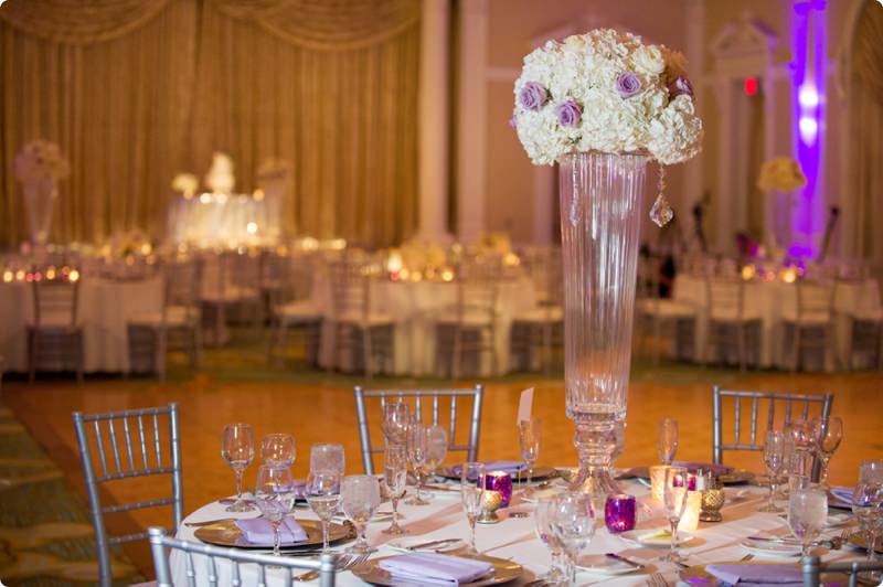 Wedding Reception Table Decor with Purple and White Flowers in Tall, Glass Centerpiece and Candlelight | St. Petersburg Wedding Venue The Vinoy Renaissance Hotel | St. Petersburg Wedding Photographer Andi Diamond Photography