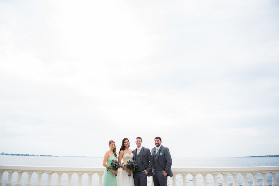 Bayshore Boulevard Waterfront Bridal Party Wedding Portrait with Green David’s Bridal Bridesmaid Dresses and Ivory, Strapless Chiffon and Soft Tulle Wedding Dress | South Tampa Wedding Photographer Kera Photography | Apple Blossoms Floral Designs Wedding Florist