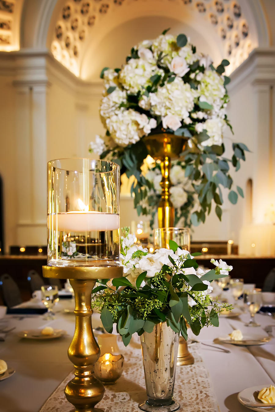 Elegant and Traditional Wedding Reception Décor with Gold and Ivory Centerpieces in Tall Vases with Cascading Greenery and Hydrangeas | St. Pete Wedding Florist Iza’s Flowers | Special Moments Wedding Planner