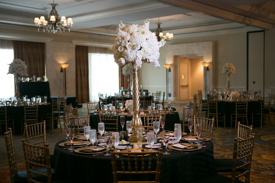Elegant Black, Gold and Ivory Wedding Reception with Tall White Flower Centerpieces, Gold Chiavari Chairs and Black Linens at Downtown Tampa Waterfront Wedding Venue Marriott Waterside | Flowers by Northside Florist | Tampa Wedding Photographer Carrie Wildes Photography
