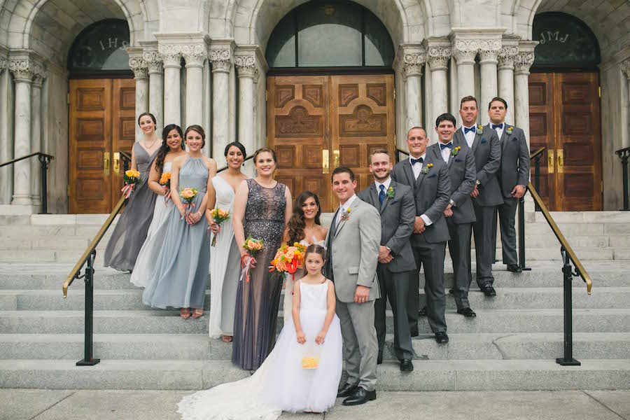 Outdoor Bridal Party Wedding Portrait | Grey Weddington Way Bridesmaid Dresses with Yellow and Orange Wedding Bouquets and Groomsmen in Grey Suits | Downtown Tampa Wedding Hair and Makeup by Lasting Luxe | Wedding Photographer Roohi Photography