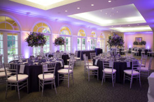Purple Wedding Reception Table Decor | Silver Chiavari Chairs, Purple and Ivory Tall Table Floral Centerpieces, and Purple Uplighting | Tampa Wedding Venue Tampa Palms Golf and Country Club