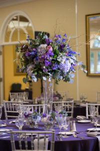Purple Wedding Reception Table Decor | Silver Chiavari Chairs and Purple and Ivory Tall Table Floral Centerpieces