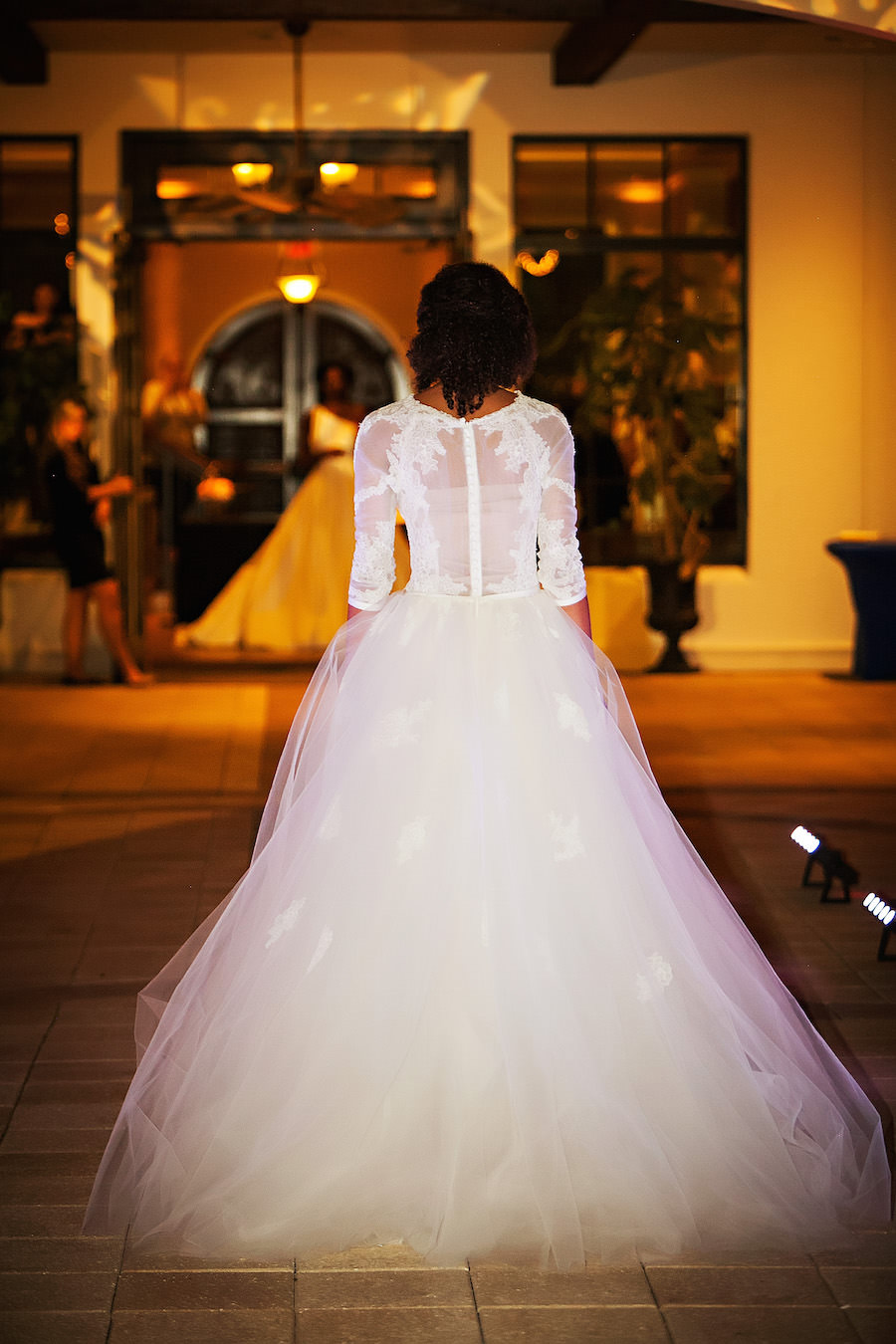 Marry Me Tampa Bay Wedding Week Fashion Show | Model in Wedding Dress with Tulle Skirt and Lace Sleeves | Tampa Bridal Salon Isabel O'Neil Bridal | Wedding Photographer Limelight Photography