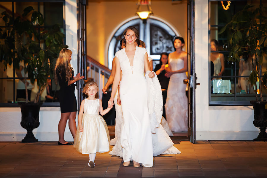 Marry Me Tampa Bay Wedding Week Fashion Show | Model in Lace Wedding Dress with Sleeves with Flower Girl | Tampa Bridal Salon Isabel O'Neil Bridal | Wedding Photographer Limelight Photography