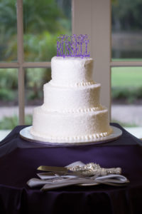 Three Tiered, White, Round Wedding Cake with Purple Cake Topper