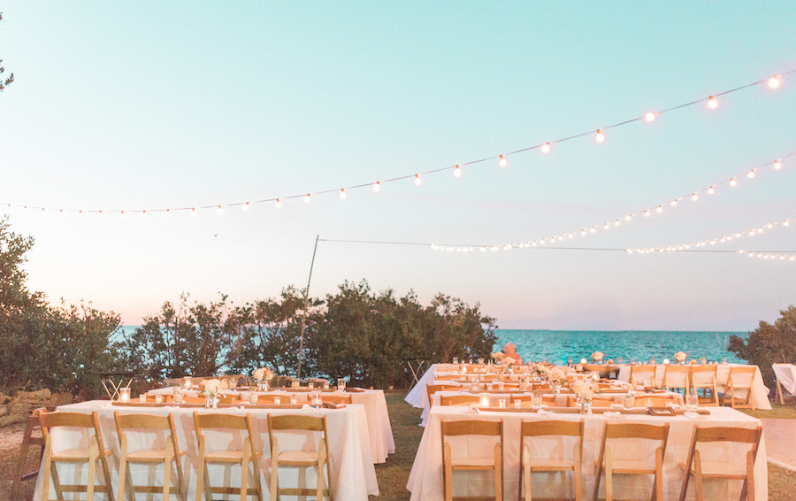 Outdoor, Tampa Bay Waterfront Wedding Reception with String Lighting and Wooden Chairs