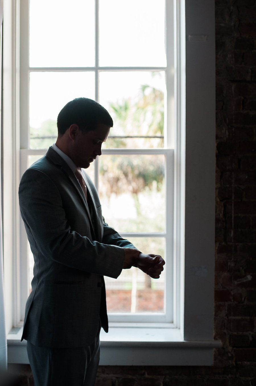 Groom Getting Dressed on Wedding Day