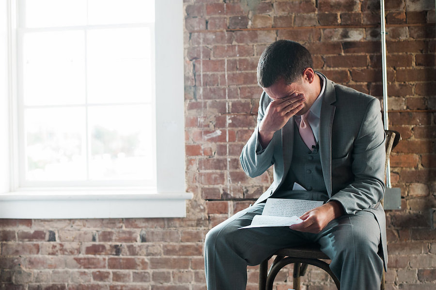 Emotional Groom Reading Letter From Bride on Wedding Day