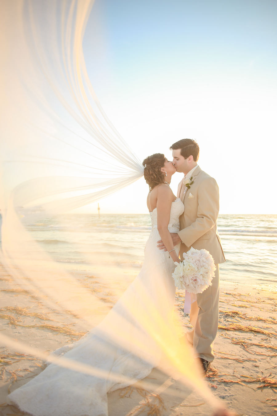 Bride and Groom Beach Wedding Portrait at Sunset Ivory Wedding Bouquet by Clearwater Wedding Florist Iza's Flowers