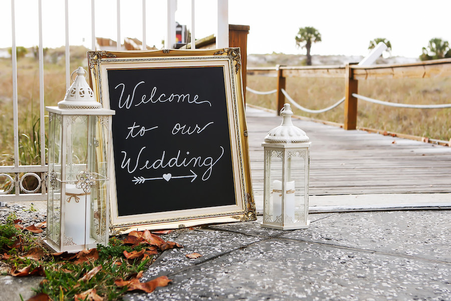 Beach Wedding Welcome Sign On Chalkboard with White Lanterns and Candles | Vintage Beach Wedding Decor Ideas