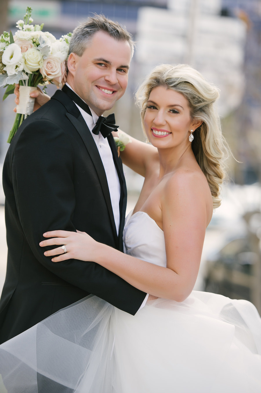 Bride and Groom Wedding Portrait in Black Tuxedo and White Strapless Sweetheart Hayley Paige Wedding Dress
