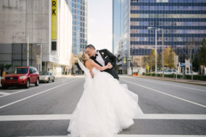 Downtown Tampa Bride and Groom Wedding Portrait in Black Tuxedo and White Strapless Sweetheart Hayley Paige Wedding Dress