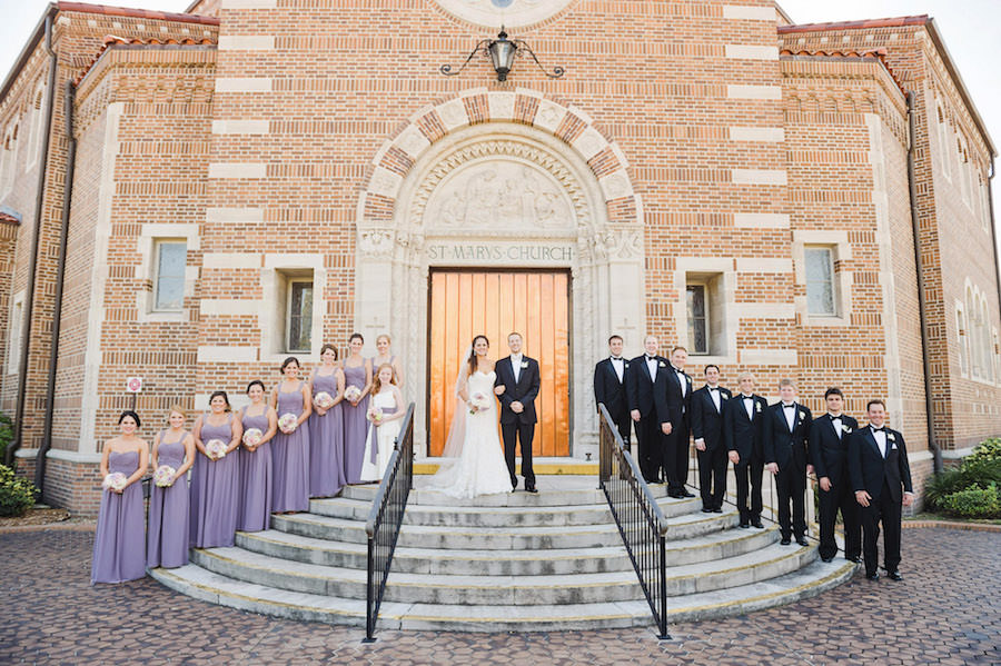 Tampa Bridal Party Wedding Portrait outside St Mary Our Lady of Grace Catholic Church | Purple Bella Bridesmaids Dresses and Ivory Lace Strapless Sottero and Midgley Wedding Dress with Pink, Lilac and Cream Rose Wedding Bouquet | Tampa Wedding Photographer Marc Edwards Photographs