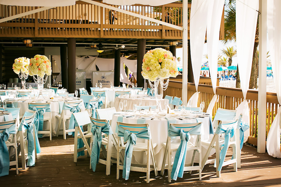 Outdoor Wedding Reception Decor with Ivory and Pink Floral Centerpieces and Light, Baby Blue Chair Sash Linens | Clearwater Wedding Florist Iza's Flowers | Clearwater Wedding Venue Hilton Clearwater Beach