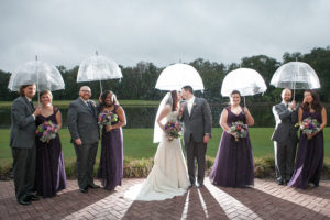 Wedding Day Bridal Party Portrait in the Rain with Clear Umbrellas | Tampa Palms Golf and Country Club | Carrie Wildes Photography