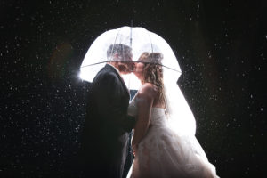 Wedding Day Bride and Groom Wedding Portrait in the Rain with Clear Umbrellas | Tampa Palms Golf and Country Club | Carrie Wildes Photography