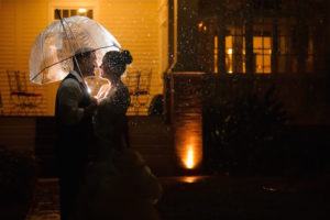 Evening Outdoor Wedding Portrait of Bride and Groom in the Rain with Clear Umbrellas | Andi Diamond Photography