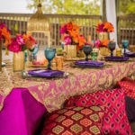 Indian Inspired Wedding Recpetion with Luxurious Gold Embroidered Table Overlays and Fuscia Tablecloths | Tampa Bay Wedding Rental Linens by Connie Duglin Specialty Linens