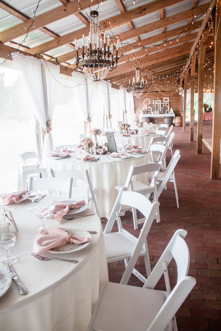Vintage Wedding Reception Decor with Pink Table Linens, Hanging Chandelier and String Lighting at Tampa BayWedding Venue Cross Creek Ranch