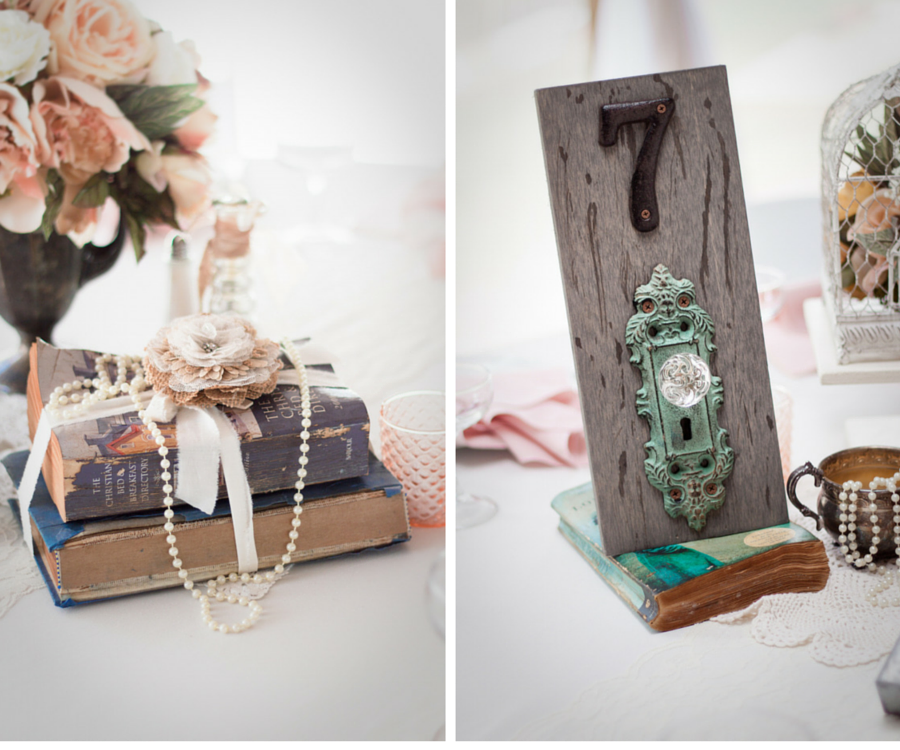 Vintage Wedding Reception Decor with Doorknob Table Number Signs and Antique Books with Strands of Pearls