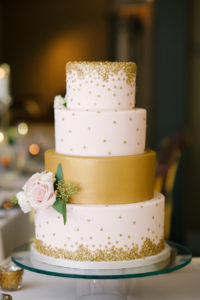 Four Tiered Round White and Gold Wedding Cake with Rose Floral Accent and Gold Sequins