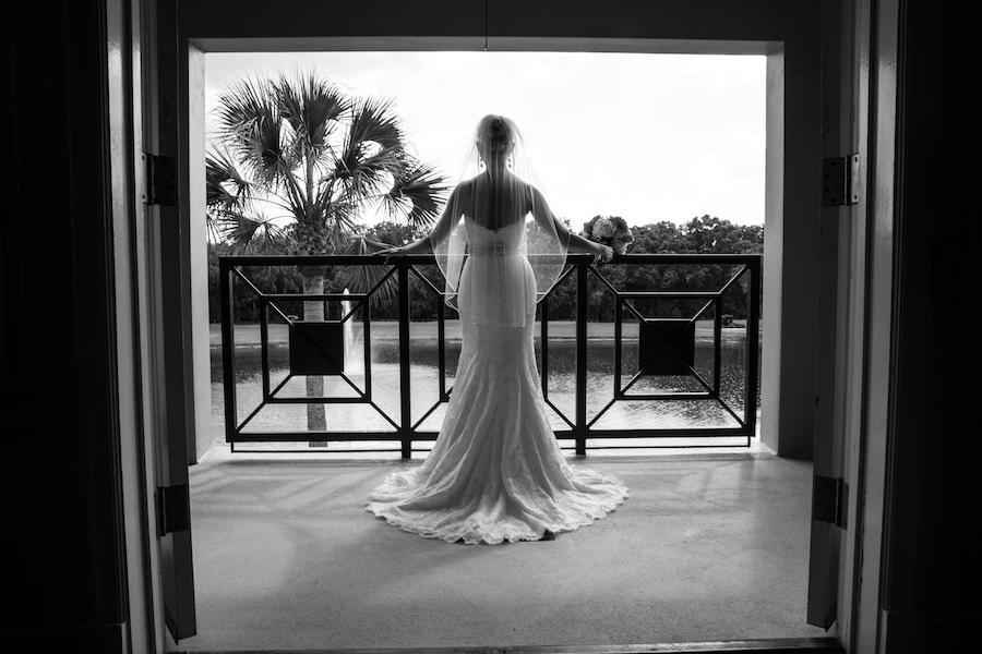Bridal Wedding Portrait on Balcony in Window in Lace, White Wedding Dress and Crystal, Rhinestone Belt, and Veil