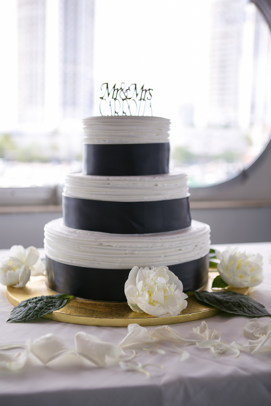 Three Tiered, Round, White Tampa Wedding Cake with Black Ribbon Detail and Ivory Flower Accents