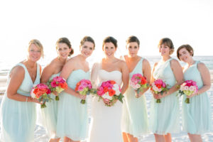 Bride and Bridesmaids Waterfront, Beach Wedding Portrait with Blue Bridesmaids Dresses and Colorful Bouquets