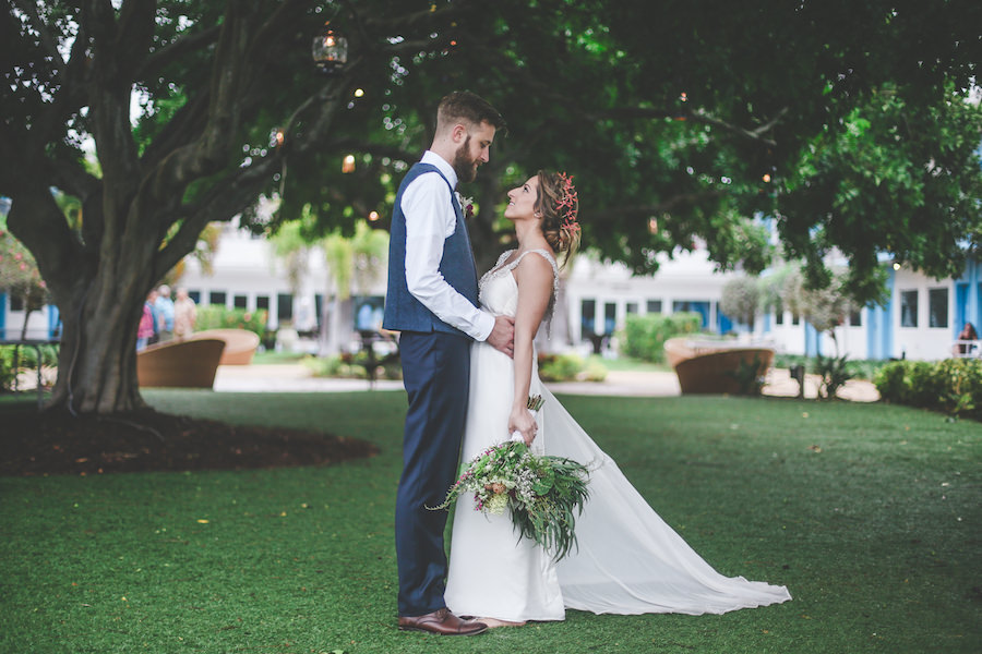 Outdoor, St. Pete Bride and Groom Wedding Portrait in Blue Groom's Suit and Beaded Anna Campbell Wedding Dress