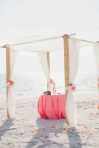 Florida Beach Wedding Ceremony Arch with Bamboo Posts and Sheer Fabric Accent by Tampa Wedding Planner UNIQUE Weddings and Events
