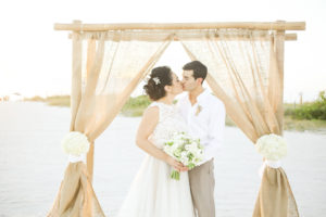 Florida Beach Wedding Ceremony Arch with Bamboo Posts and Burlap Fabric Accent by Tampa Wedding Planner UNIQUE Weddings and Events