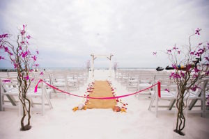 Florida Beach Wedding Ceremony Arch with Bamboo Posts and Floral Accent by Tampa Wedding Florist Iza's Flowers at Hilton Clearwater Beach