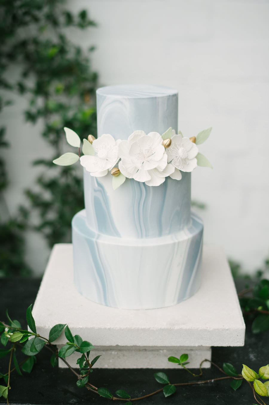 Blue Grey and White Marble Three Tiered Minimalist Wedding Cake with Ivory Sugar Flowers with Green Leaf Accent | Tampa Wedding Cakes and Desserts Hands on Sweets