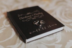 Bride and Groom Wedding Bands and Engagement Rings on Guest Book
