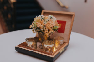 Old Tampa Themed Wedding Reception Cocktail Table Decor with Candlelight, Peach and Ivory Flowers, and Cigar Boxes