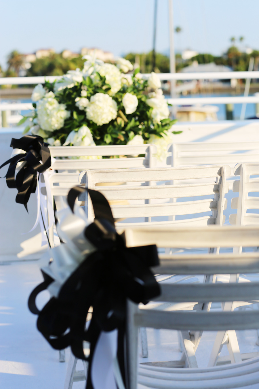 Clearwater Wedding Venue Yacht Starship Sensation Ceremony with White Chairs and White Floral Arrangements