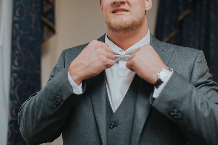 Groom Getting Dressed in Grey Suit and White Bowtie | Cleveland Browns Football Player Charley Hughlett Wedding