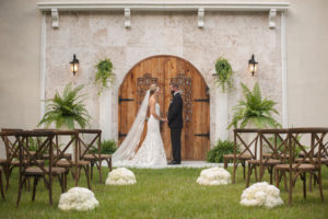 Southern Inspired Wedding Bride and Groom Outdoor Wedding Ceremony Portrait in Black Tuxedo and Ivory Strapless Trumpet Wedding Dress | Sarasota Wedding Venue Bakers Ranch