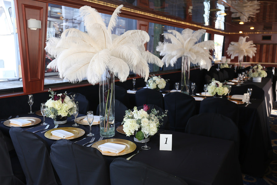 Indoor Wedding Reception Table Decor with Tall, White Feather Centerpieces and Ivory Floral Arrangements | Clearwater Waterfront Wedding Venue Yacht Starship Sensation