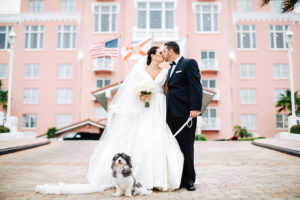 Bride and Groom Wedding Portrait with Pet Dog at Tampa Bay Pet Friendly Wedding Venue Loews Don CeSar Hotel | Tampa Wedding Day Pet Care by FairyTail Pet Care