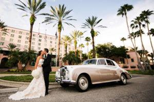 Bride and Groom Wedding Portrait in Ivory Strapless Lace Wedding Dress with Ivory Rose Wedding Bouquet at St. Petersburg Wedding Venue Vinoy Renaissance with Vintage Rolls Royce Limousine | St Pete Wedding Photographer Limelight Photography