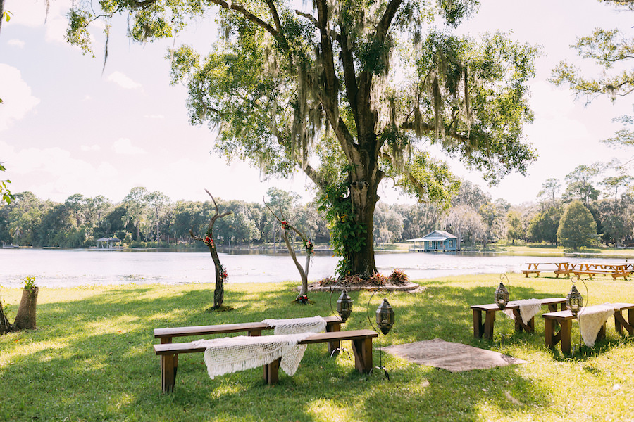 Boho Chic Wedding Ceremony with Bench Seating Waterfront Lake Backdrop | Rustic Tampa Bay Wedding Venue The Barn at Crescent Lake at Old McMicky's Farm