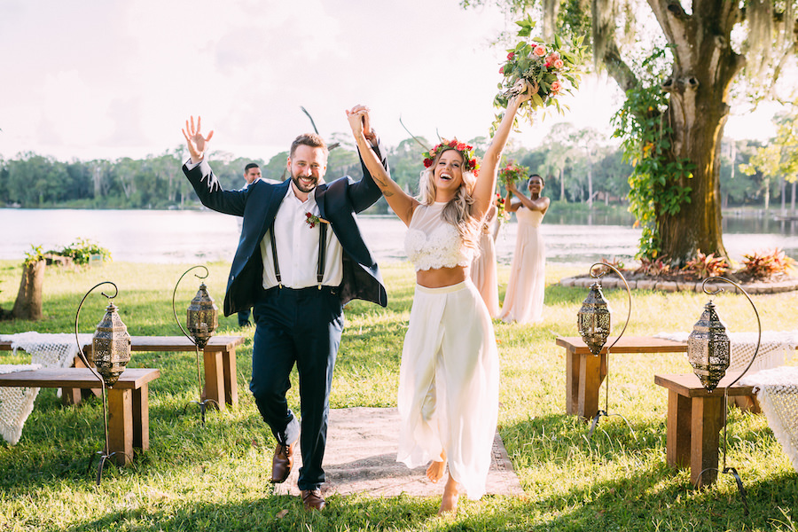 Outdoor Tampa Wedding Ceremony Portrait of Bride and Groom in Two Piece Wedding Dress | Outdoor Tampa Bay Lakefront Wedding Venue The Barn at Crescent Lake | Waterfront Wedding Ceremony with Farm Benches from Ever After Vintage Weddings