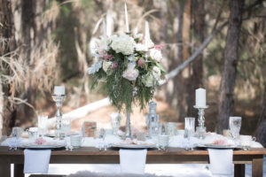Nutcracker Ballet Styled Wedding Shoot | Outdoor Winter Inspired Wedding Reception with Faux Fur and Wooden Farm Tables with Silver Charger Plates with Vintage China Dishes with Tall Ivory Blush and Pink Floral Centerpieces | Ever After Vintage Weddings Tampa Bay Wedding Rental Company and Event Stylist