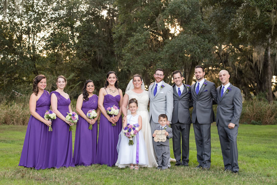 Outdoor Bridal Party Wedding Portrait | Mix and Match Purple Bridesmaid Dresses with Ivory Cap Sleeve Rounded Neckline Wedding Dress and Purple, Pink and Ivory Wedding Bouquet | Caroline and Evan Photography