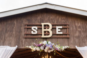 Rustic Glam Barn Wedding Reception at Tampa Wedding Venue Cross Creek Ranch with Custom Monogram and Cascading Overhead Floral Arrangement | Rustic Wedding Ideas and Inspiration