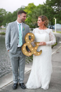 Bride and Groom Outdoor Florida Wedding Portrait with Ampersand Marquee Sign