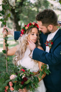 Bohemian Chic Inspired Wedding Portrait with Bride with Floral Crown Headpiece and Groom with Navy Suit on Swing at The Barn at Crescent Lake