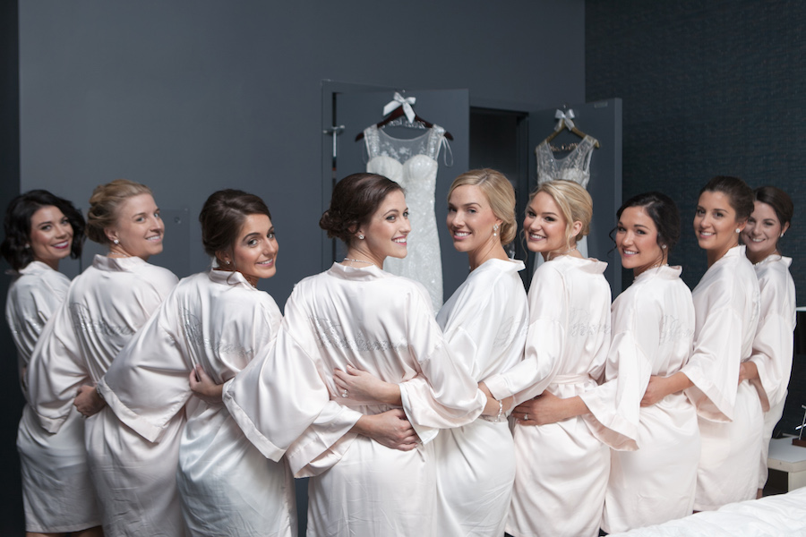 Bridal Party Getting Ready In Custom Monogrammed Bridesmaids Satin Ivory Robes | Tampa Wedding Photographer Carrie Wildes Photography